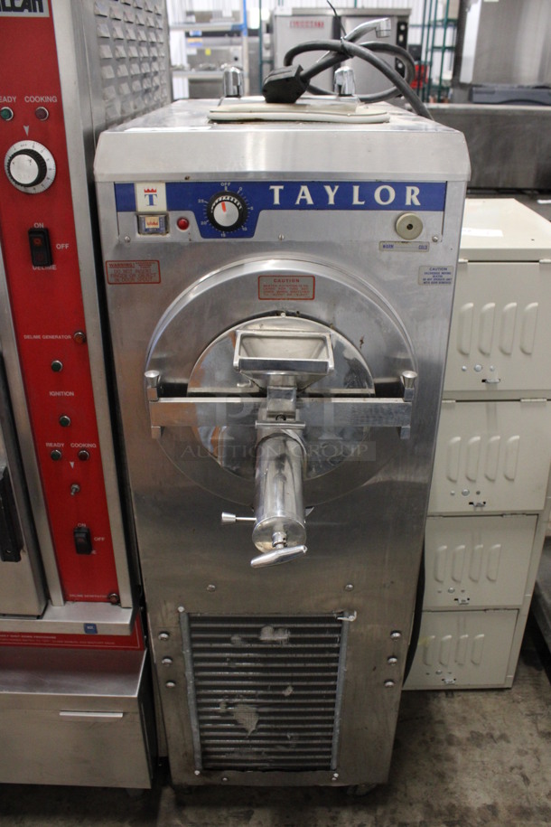 Taylor Model 121-27 Stainless Steel Commercial Floor Style Water Cooled Batch Freezer on Commercial Casters. 208/230 Volts, 1 Phase. 18x40x60