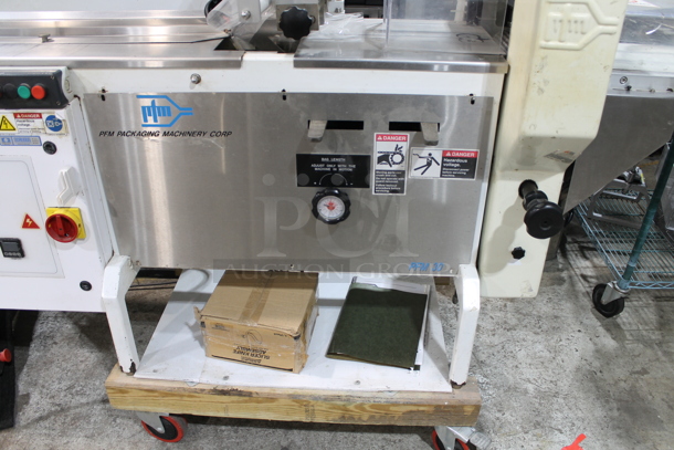 PFM Packaging 30 M Metal Commercial Floor Style Horizontal Form Fill and Seal / Horizontal Flow Wrapper Machine on Commercial Casters. 220 Volts, 1 Phase.  - Image 4 of 11