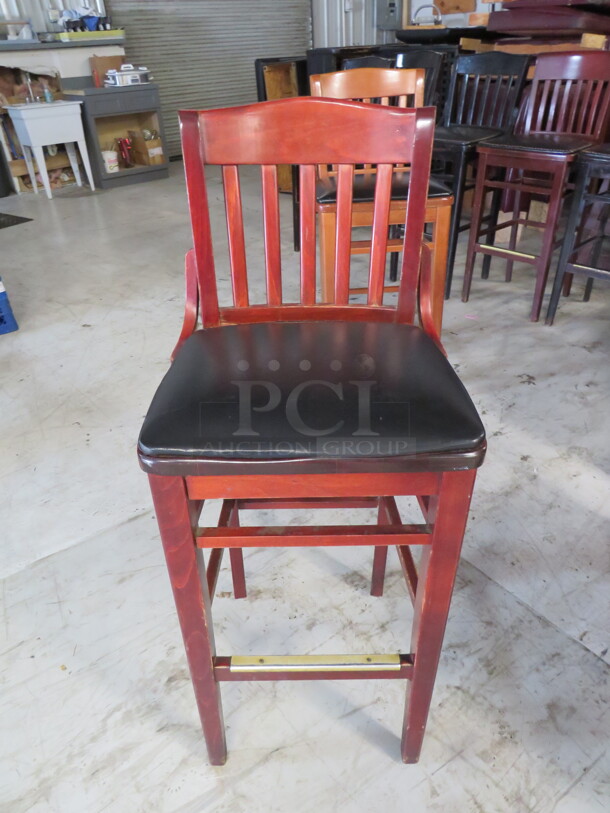 One Wooden Bar Height Chair With A Black Cushioned Seat. 