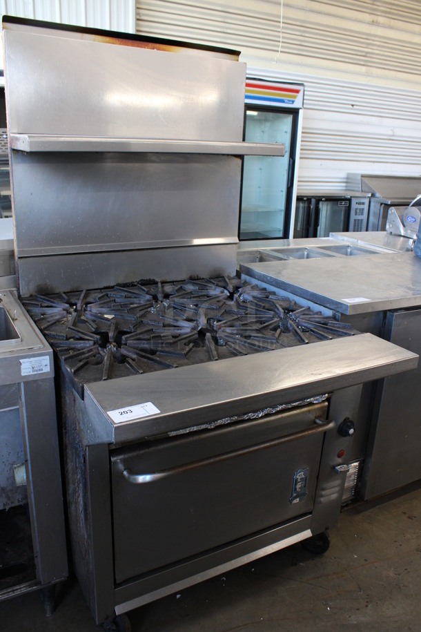 Montague Stainless Steel Commercial Propane Gas Powered 6 Burner Range w/ Oven and Over Shelf on Commercial Casters. 36x42x72