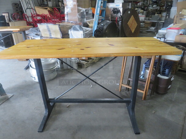 One Wooden Table Top On A Bar Height Black Industrial Base. 71.5X28X42