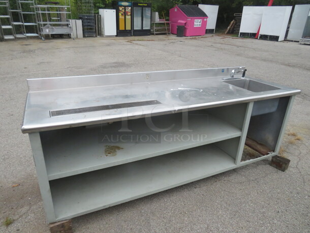 One Stainless Steel Drink Table With Drain And Sink, Faucet, 2 SS Under Shelves, And A Backsplash. Missing Legs. 96X30X40. - Image 1 of 2