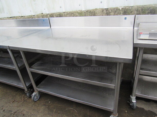 One Stainless Steel Table With 2 Stainless Under Shelves, On Casters. 48X32X40