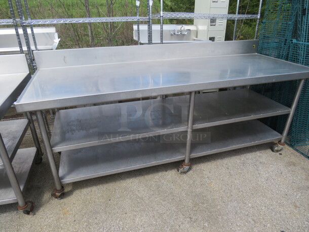 One Stainless Steel Table With 2 Stainless Steel Undershelves, And Back Splash, On Casters. 90X32X40 - Image 1 of 1