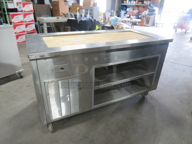 One Delfield Stainless Steel Serving Table With A 50X20X6 Well, And 2 Stainless Under Shelves, On Casters. 63X30X36 