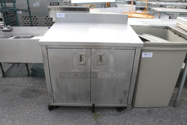 Stainless Steel Commercial Counter w/ Back Splash, Under Shelves and 2 Doors. - Image 1 of 3