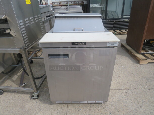 One SS Delfield 1 Door Refrigerated Prep Table With Cutting Board With 1 Rack On Casters. 27.5X32X42