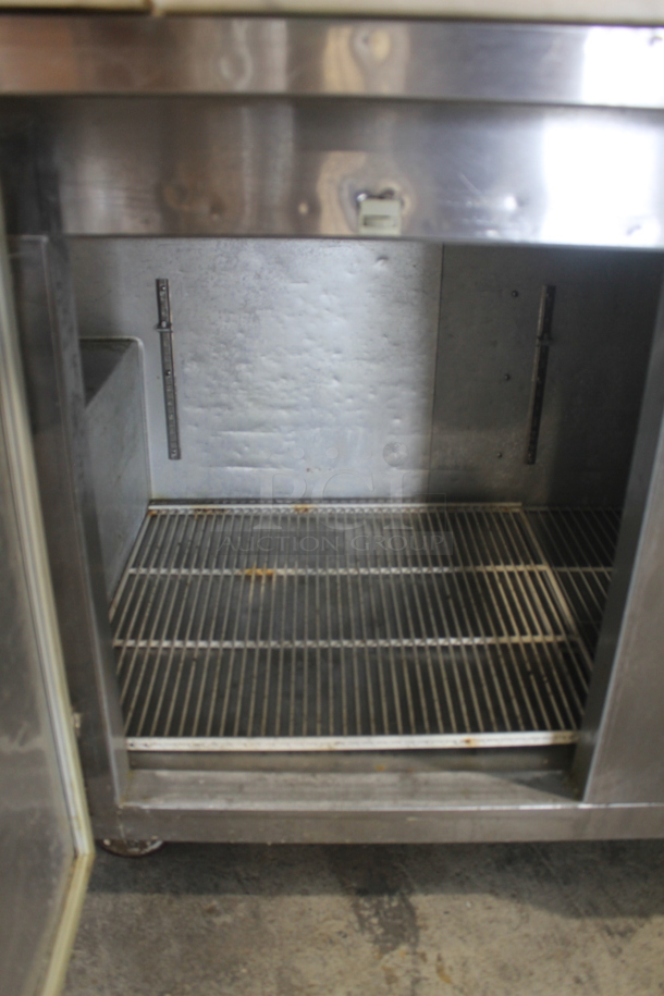 2014 Leader ESPT72SC Commercial Stainless Steel 3-Door Pizza Prep Table With Marble Style Countertop, Lift Up Lids, Plastic Drop-In Bins And Steel Racks On Commercial Casters. 115V. Tested and Powers On But Does Not Get Cold
 - Image 7 of 10