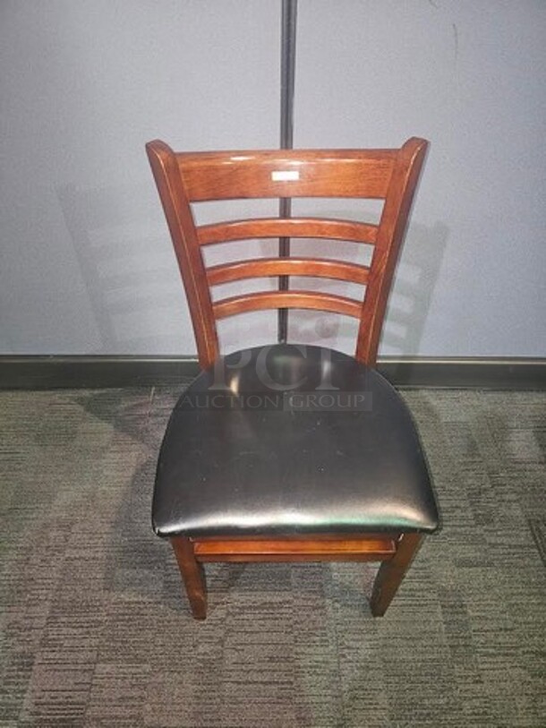 Wooden restaurant chair with black leather seat- 18.5" W x 33.5" L x 15" D. In good used condition, no broken pieces but have some marks and scuffs from normal wear. BIDX6 - Image 3 of 3