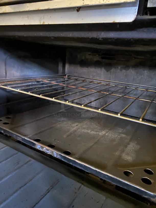 Commercial Natural Gas Powered 4 Burner Stove! With Built In Flat Top Grill! With Back Splash And Salamander Shelf! With Full Size Oven! Metal Oven Rack! With 2 Door Storage Area Underneath! All Stainless Steel! - Image 9 of 12