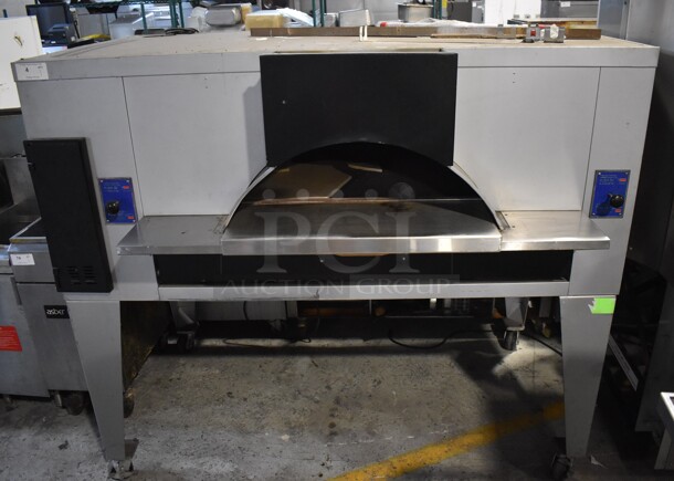 LIKE NEW! Bakers Pride Stainless Steel Commercial Natural Gas Powered Floor Style Il Forno Single Deck Pizza Oven on Metal Legs w/ Commercial Casters. 78x54x68