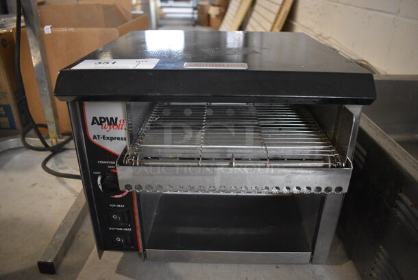 APW Wyott Model AT EXPRESS Stainless Steel Commercial Countertop Electric Powered Conveyor Toaster Oven. 120 Volts, 1 Phase. 15x17x13. Tested and Working!