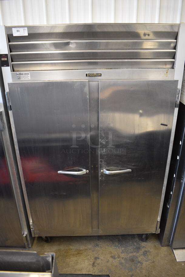 Traulsen Model G22010 ENERGY STAR Stainless Steel Commercial 2 Door Reach In Freezer w/ Poly Coated Racks on Commercial Casters. 115 Volts, 1 Phase. 52x34x77. Tested and Does Not Power On