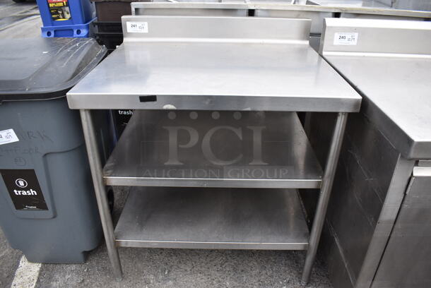 Stainless Steel Table w/ Back Splash and 2 Under Shelves. 36x30x41