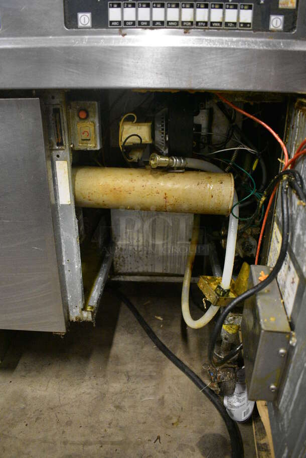 2010 Frymaster Model BIGLA330CSD Stainless Steel Commercial Floor Style Natural Gas Powered 3 Bay Deep Fat Fryer w/ 6 NEW Metal Fry Baskets and 2 Lids on Commercial Casters. 75,000 BTU. 48x33x48.5 - Image 10 of 11