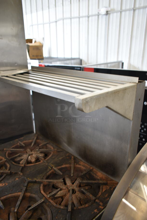 Garland M44R Stainless Steel Commercial Natural Gas Powered 4 Burner Range w/ Oven, Over Shelf and Back Splash on Commercial Casters.  - Image 2 of 9