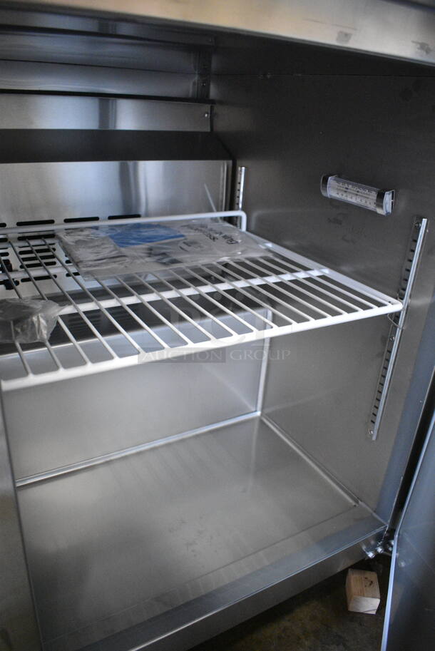 BRAND NEW SCRATCH AND DENT! 2024 Avantco 178SSUC48FHC Stainless Steel Commercial 2 Door Undercounter Freezer on Commercial Casters. 115 Volts, 1 Phase. Tested and Working! - Image 5 of 7