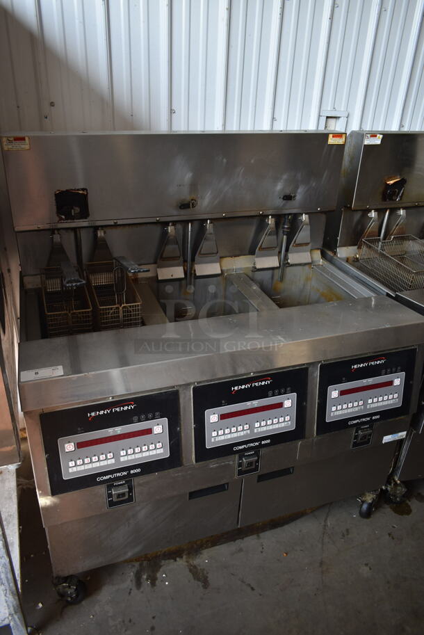 2016 Henny Penny OGA-323 ENERGY STAR Stainless Steel Commercial Natural Gas Powered 3 Bay Fryer w/ 4 Metal Fry Baskets on Commercial Casters. 255,000 BTU.  - Image 2 of 12