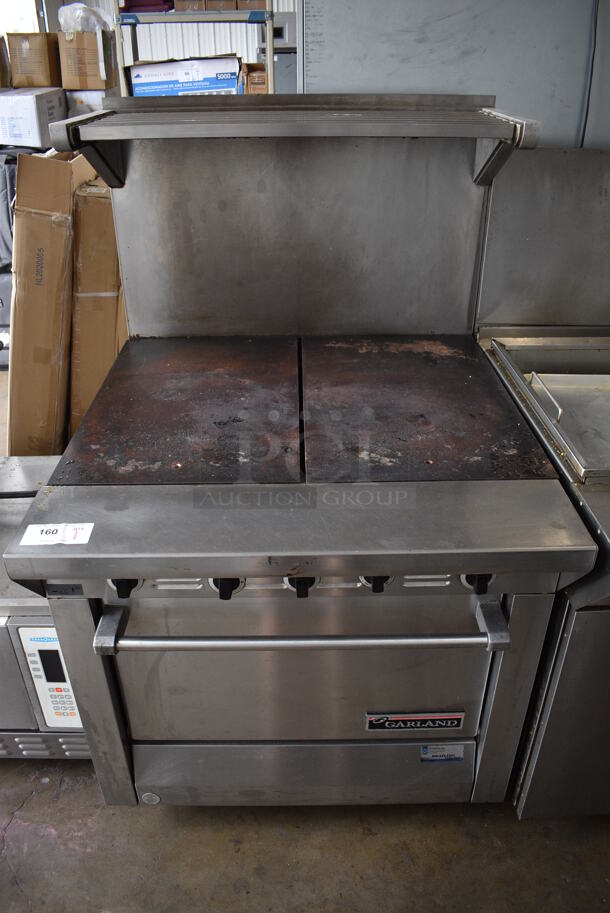 Garland M46R Stainless Steel Commercial Natural Gas Powered Flat Top Griddle w/ Oven, Over Shelf and Back Splash on Commercial Casters. 34x38.5x57