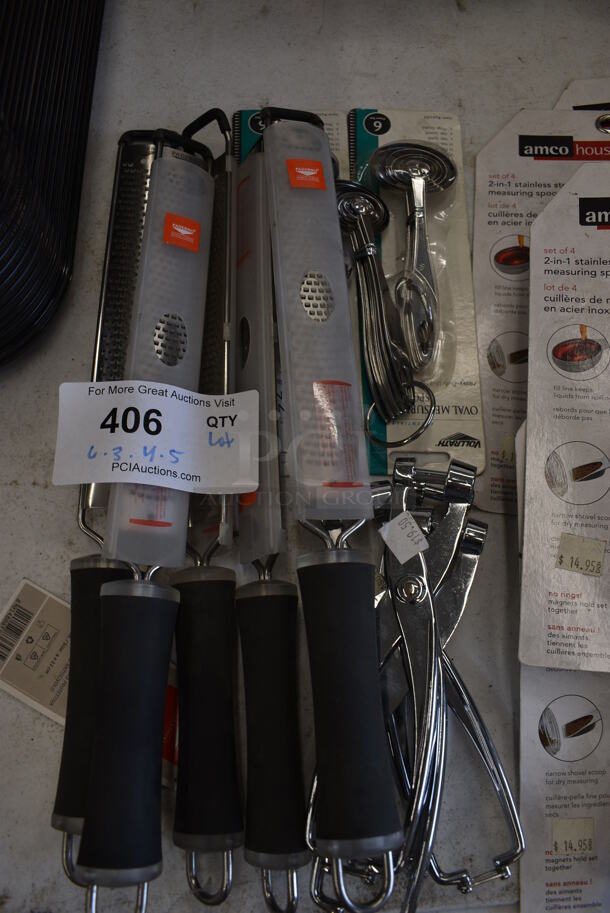 ALL ONE MONEY! Lot of Various BRAND NEW! Stainless Steel Utensils; 6 Zesters, 3 Measuring Cup Sets, 4 Cherry Pitters and 5 Measuring Spoon Sets. - Image 3 of 4