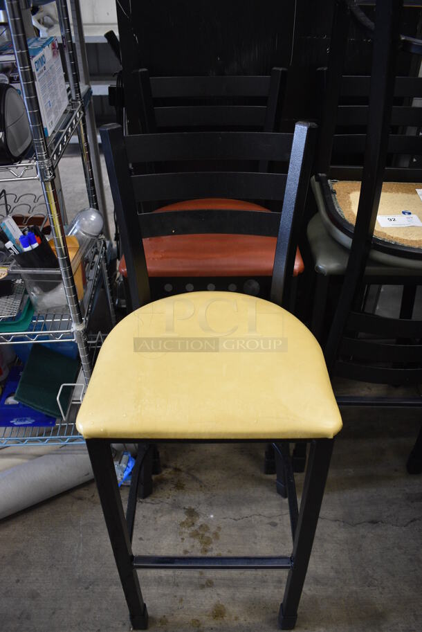 2 Black Metal Bar Height Chairs; Yellow and Red Seat Cushions. 17x18x44. 2 Times Your Bid!