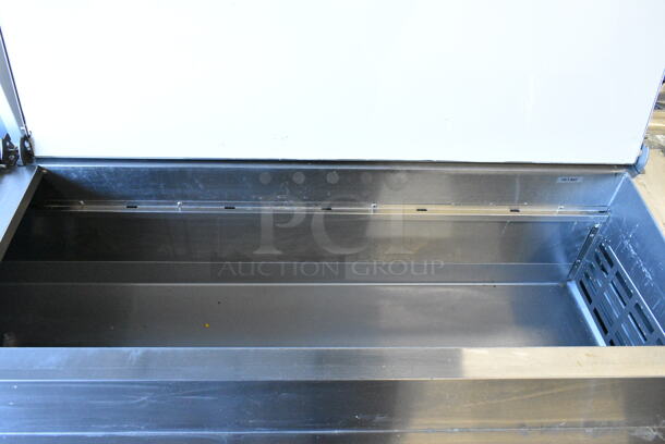 BRAND NEW SCRATCH AND DENT! 2024 Avantco 178APPT91HC Stainless Steel Commercial 3 Door Refrigerated Pizza Prep Table. 115 Volts, 1 Phase. Tested and Working! - Image 7 of 9