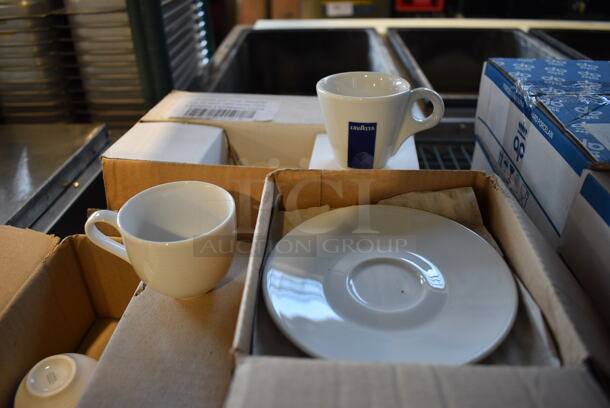3 Various Boxes of White Ceramic Dishes; 6 White Ceramic Mugs, 12 Lavazza White Ceramic Mugs and 12 White Ceramic Saucers. Includes 5x5x1. 3 Times Your Bid! - Image 1 of 6