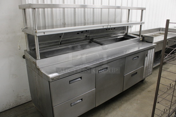 Delfield Stainless Steel Commercial Pizza Prep Table w/ Door, 4 Drawers and Double Over Shelf on Commercial Casters. 99x32x66. Tested and Working!