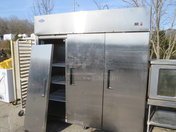 One Atosa 3 Door Stainless STeel Freezer With 9 Racks On Casters. 115/208-230 Volt. 1 Phase. Model# MBF8003. 78X32X82. Door Needs To Be Reattached.  - Image 1 of 3