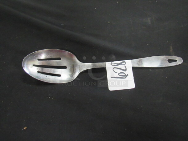 One Stainless Steel Slotted Spoon. 