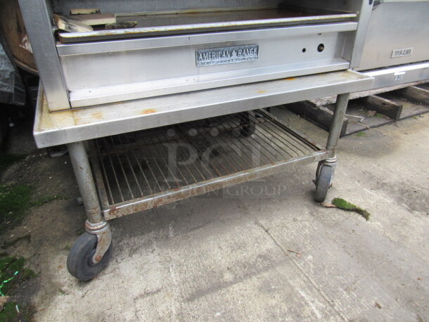 One Stainless Steel Equipment Table With A Metro Under Shelf On Casters. 36X26X17
