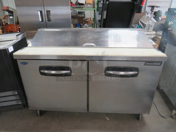 One Norlake 2 Door Advantage Refrigerated Prep Table With 2 Racks, Cutting Board On Casters. Model# SP60-16-030. Working Not Cold. 115 Volt. 60X30X43.
