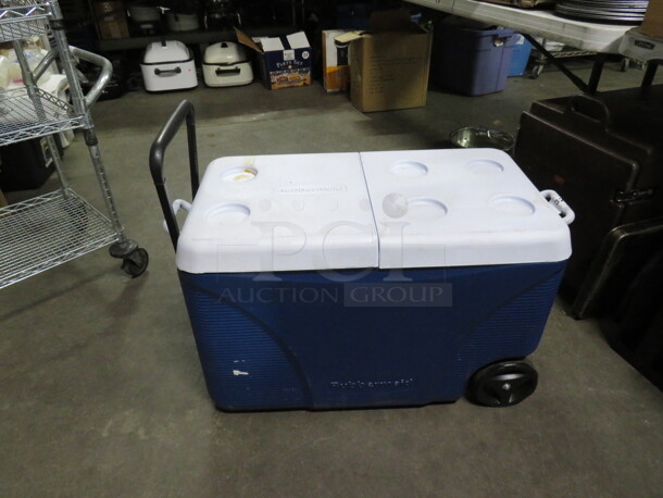 One Rubbermaid Wheeled Cooler With A Dual Flip Lid.
