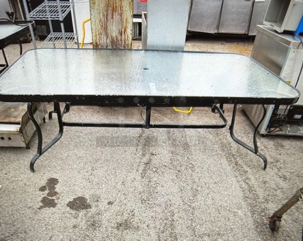 One Patio Table With A Glass Top And Umbrella Hole. 84X42X27