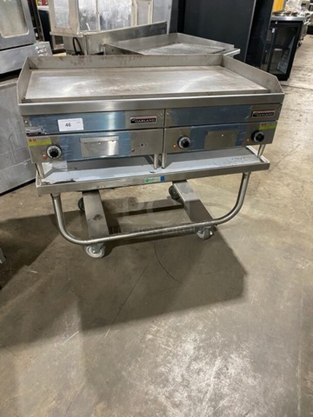 WOW! NEW! NEVER USED! Garland Commercial Countertop Electric Powered Flat Top Griddle! With Back And Side Splashes! On Legs! On Equipment Stand! All Stainless Steel! On Casters! Model: E2448G SN: 0404ME0033 208V 60HZ 3 Phase