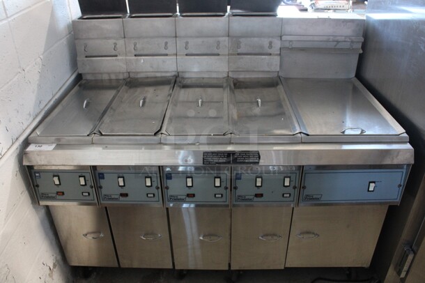 Pitco Frialator Model F7SS-CJMQV Stainless Steel Commercial Floor Style Natural Gas Powered 4 Bay Deep Fat Fryer w/ Right Side Dumping Station and 5 Lids on Commercial Casters. 55,000 BTU. 57x34x53