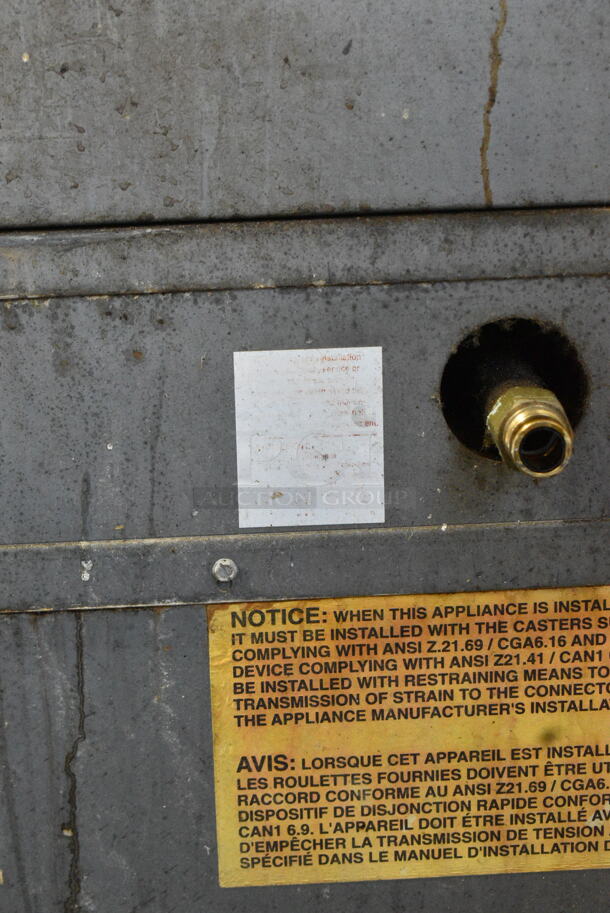 US Range C836-7 Stainless Steel Commercial Natural Gas Powered 4 Burner Range w/ Oven and Back Splash on Commercial Casters.  - Image 7 of 9