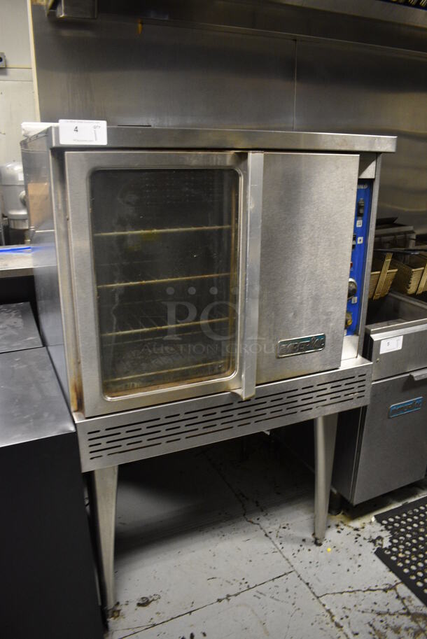 Imperial Stainless Steel Commercial Gas Powered Full Size Convection Oven w/ View Through Door, Solid Door, Metal Oven Racks and Thermostatic Controls on Metal Legs. 36x41x61. BUYER MUST REMOVE. Item Was in Working Condition on Last Day of Business. (kitchen)
