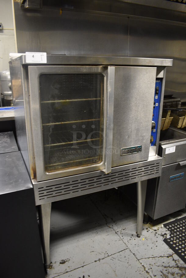 Imperial Stainless Steel Commercial Gas Powered Full Size Convection Oven w/ View Through Door, Solid Door, Metal Oven Racks and Thermostatic Controls on Metal Legs. 36x41x61. BUYER MUST REMOVE. Item Was in Working Condition on Last Day of Business. (kitchen) - Image 1 of 6