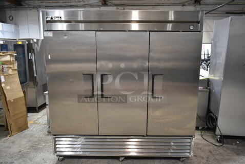 True T-72F Stainless Steel Commercial 3 Door Reach In Freezer w/ Poly Coated Racks on Commercial Casters. 115/208-230 Volts, 1 Phase.  