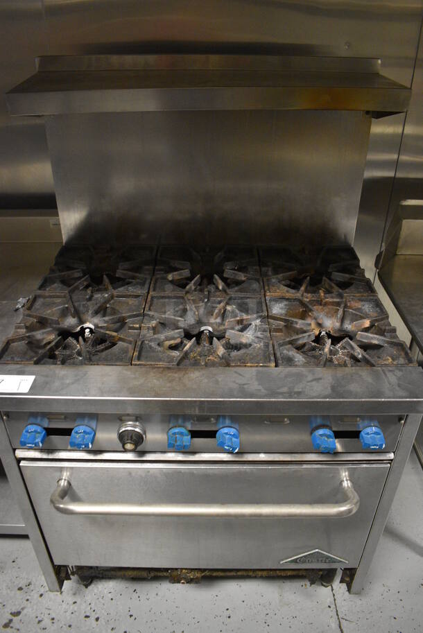 Prince Castle Stainless Steel Commercial Gas Powered 6 Burner Range w/ Oven, Over Shelf and Back Splash. 36x34x59. BUYER MUST REMOVE. Item Was in Working Condition on Last Day of Business. (kitchen)