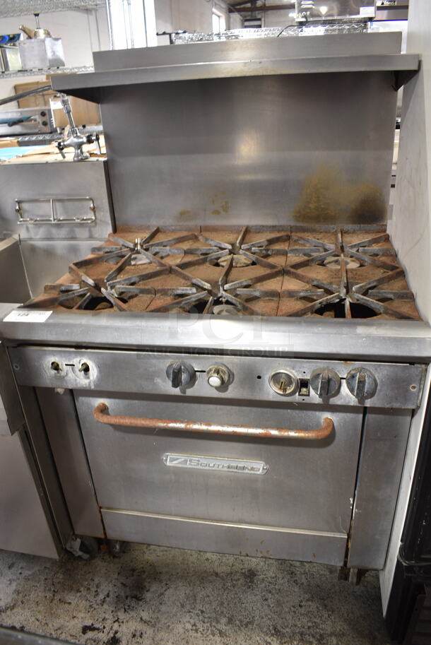 Southbend Stainless Steel Commercial Natural Gas Powered 6 Burner Range w/ Oven, Over Shelf and Back Splash on Commercial Casters.  - Image 1 of 9
