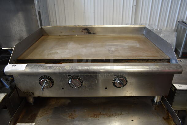 APW Wyott Stainless Steel Commercial Countertop Natural Gas Powered Flat Top Griddle.  - Image 1 of 7
