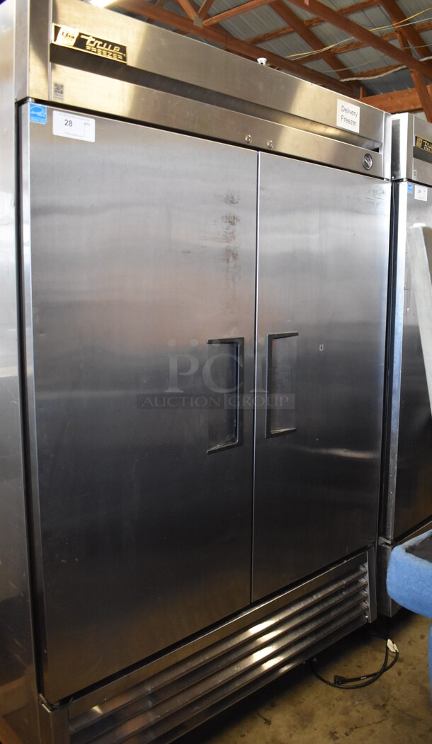 2013 True T-49F ENERGY STAR Stainless Steel Commercial 2 Door Reach In Freezer w/ Poly Coated Racks on Commercial Casters. 115 Volts, 1 Phase. Tested and Powers On But Does Not Get Cold