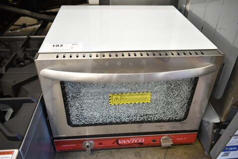 BRAND NEW SCRATCH AND DENT! Avantco 177CO14 Stainless Steel Commercial Countertop Electric Powered Quarter Size Convection Oven. See Pictures for Glass Damage. 120 Volts, 1 Phase. Tested and Working!