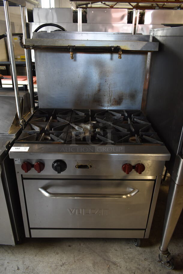 Vulcan Stainless Steel Commercial Natural Gas Powered 6 Burner Range w/ Oven, Over Shelf and Back Splash on Commercial Casters. 