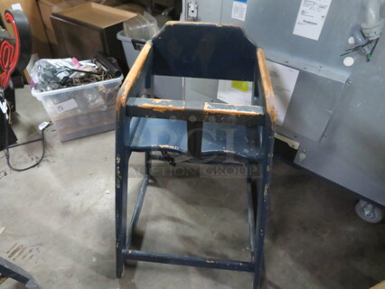 One Wooden High Chair With Safety Straps.