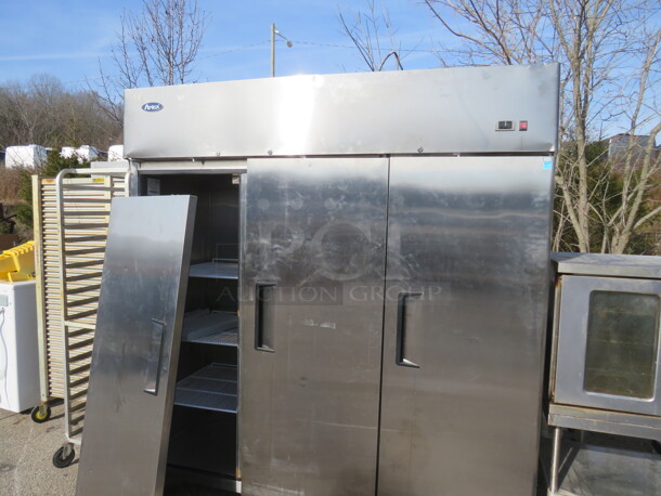 One Atosa 3 Door Stainless STeel Freezer With 9 Racks On Casters. 115/208-230 Volt. 1 Phase. Model# MBF8003. 78X32X82. Door Needs To Be Reattached.  - Image 2 of 3
