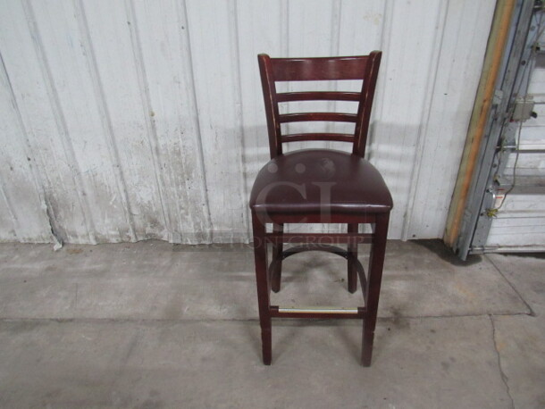 Wooden Bar Stool With A Cushioned Seat And Footrest. 2XBID