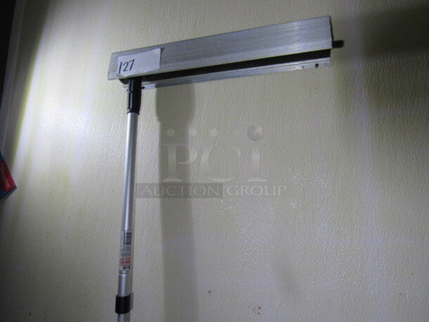 One 18 Inch Wall Mount Holder With Squeegee. BUYER MUST REMOVE!.